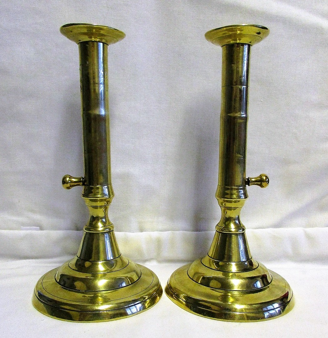 A Pair of English Push-up Brass Candlesticks, with Scalloped Edge