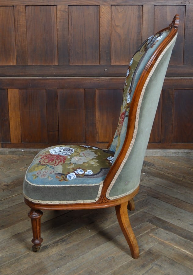 A Victorian walnut framed spoon back salon nursing chair with