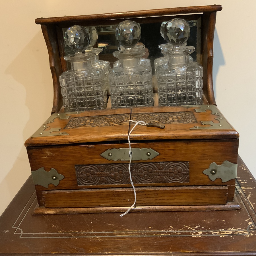 Tantalus three decanter’s & Games in oak case Antique Glassware